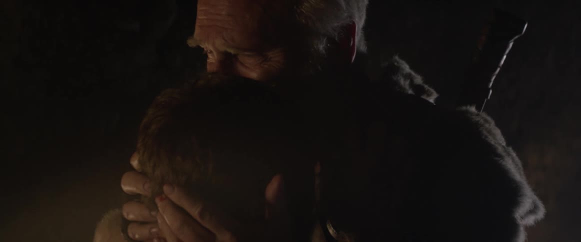 A man has his beard touched
