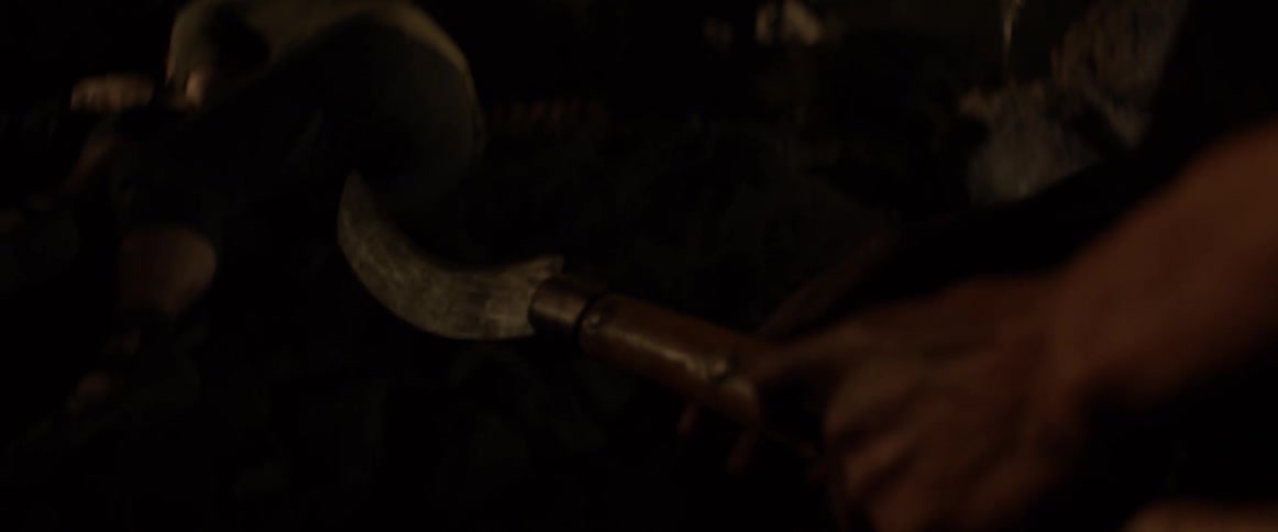 A man picks up and handles a blade
