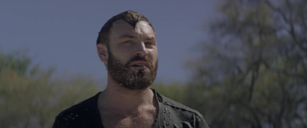 Bearded man turns his head as he looks around