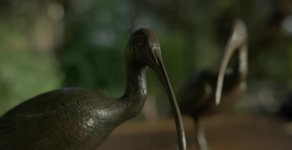 A bronze sculpture of a stork
