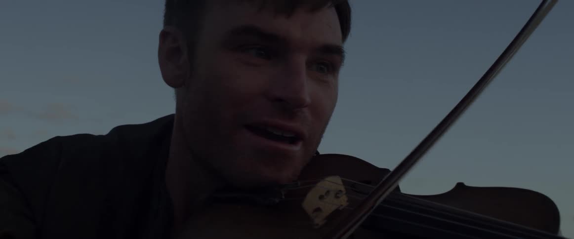 A man is playing the violin