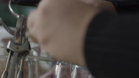 Woman cracks eggs into bowl