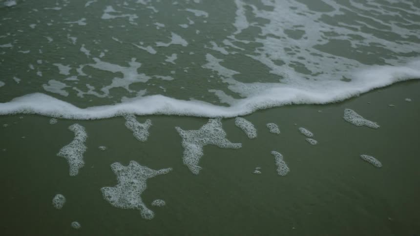 Water splashing onto a sandy beach