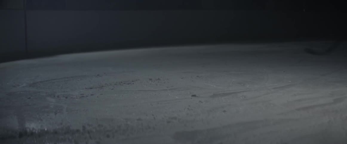 A hockey player skates off and slides to a stop