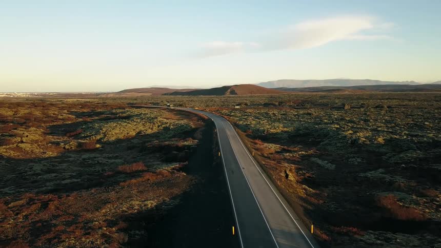 The road is empty below on a sunny day in Iceland