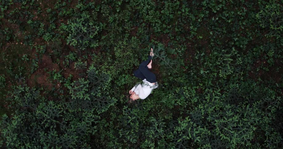 A woman is sleeping on the field