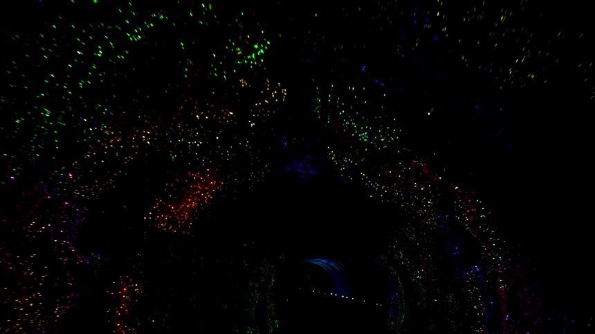 Lights shine and flash in a dark tunnel