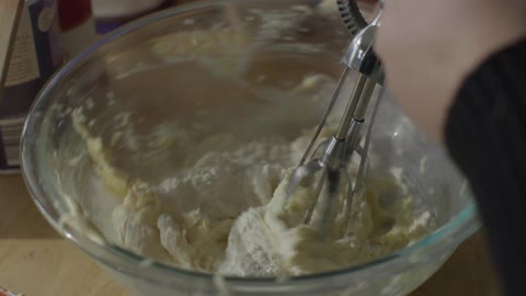 Flour is whisked into a bowl