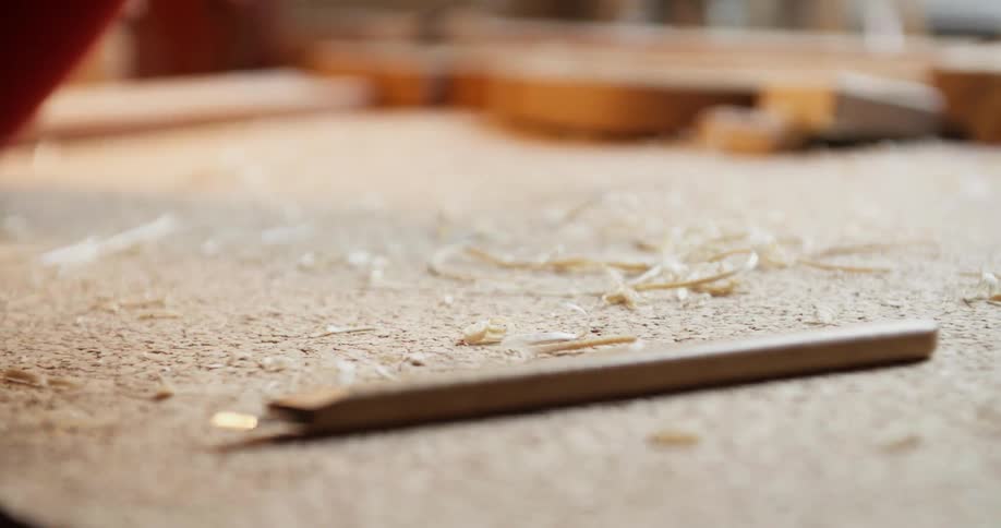 Wooden shavings falling onto a table
