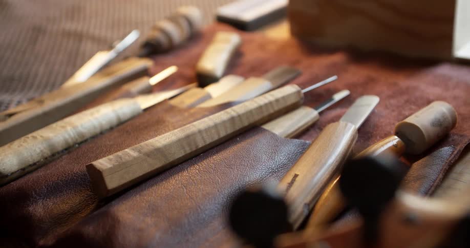 Top of a violin and tools on a table