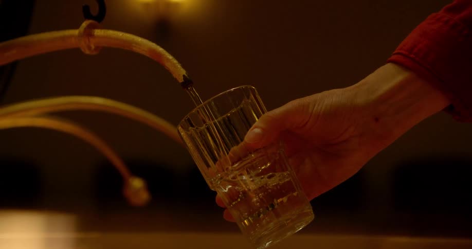 A person is filling a glass of water