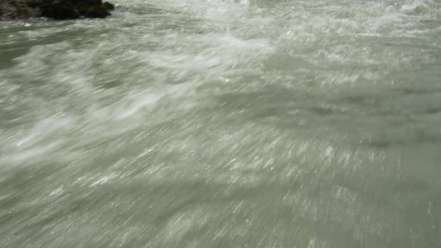 A stream flows over and around rocks