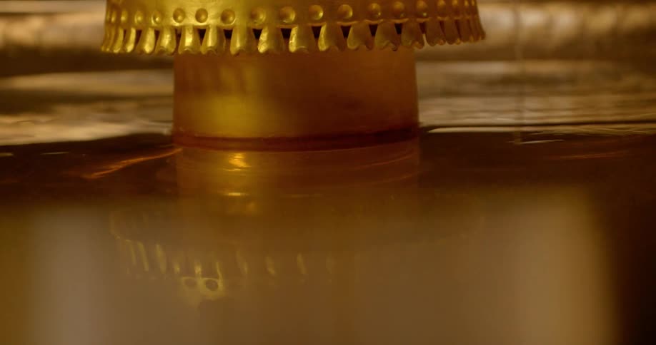The water is calm in this gold fountain
