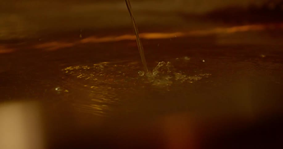 Dirty-looking liquid pouring into a container