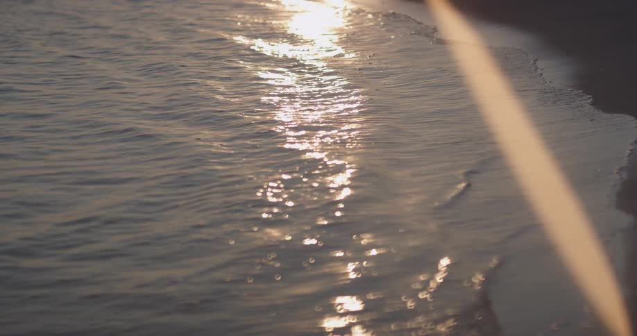 The waves slowly pour onto the beaches shore