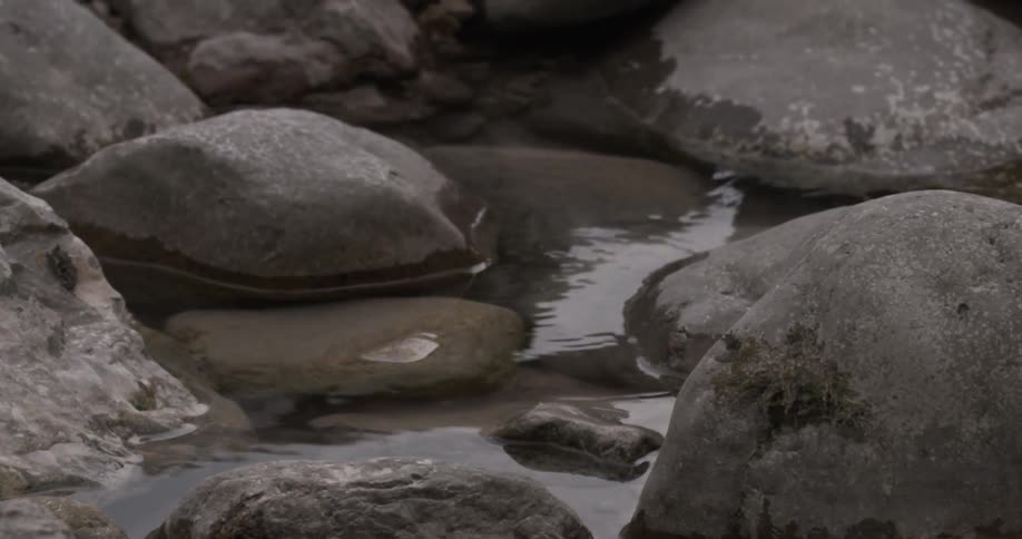 The group of rocks has water in the middle