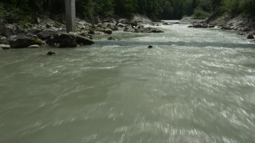 Water flows in a river through and around rocks