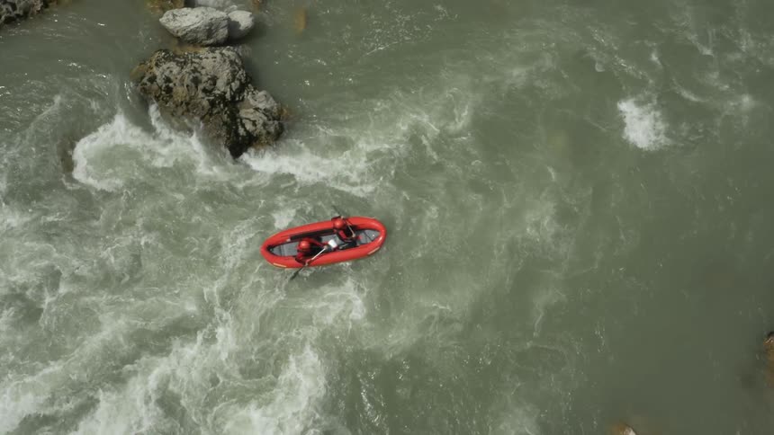 A raft is paddled down a fast flowing river