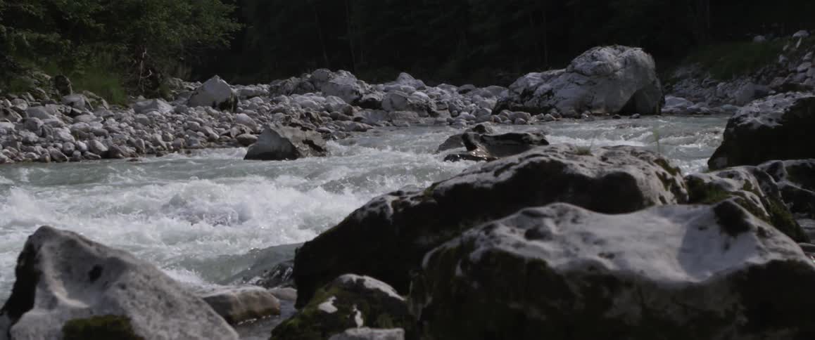 The rapids move fast and are surrounded by stones
