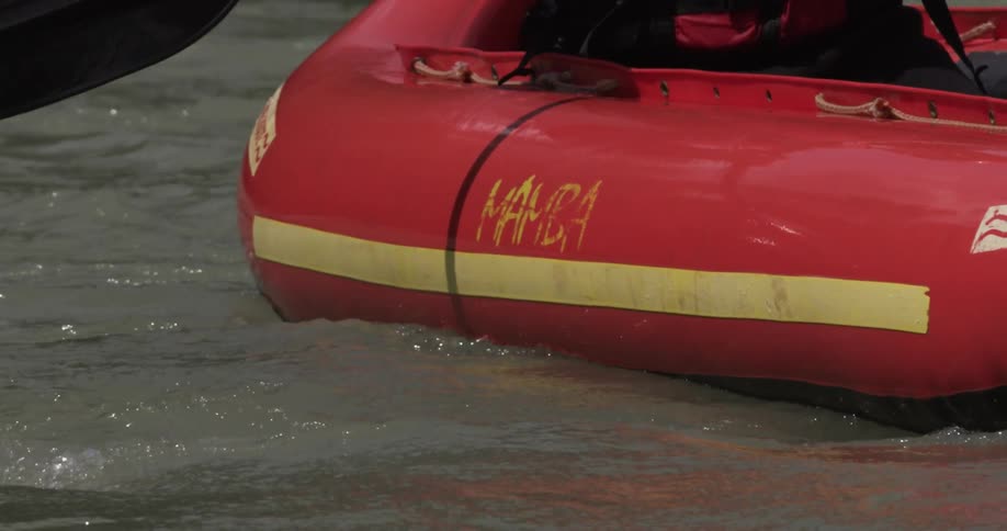 A man is rowing his raft in the water