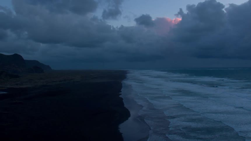 Water waves crashing to shore on a cloudy day