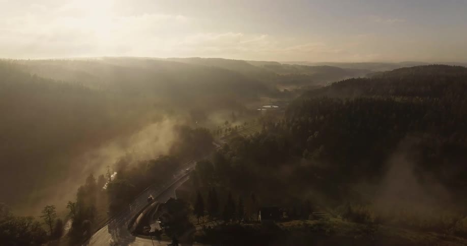 A drone is filming a foggy valley