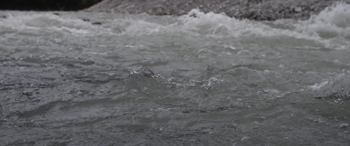 Water rushes and splashes in a river