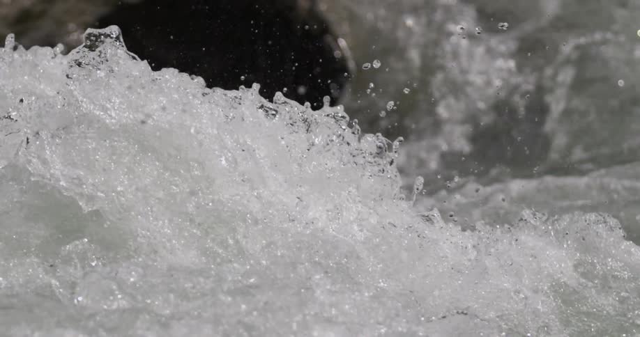 Slow motion close up footage of a white water rapid