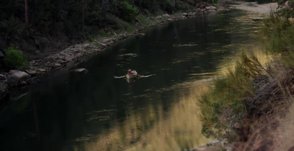 A boat is paddled down a river