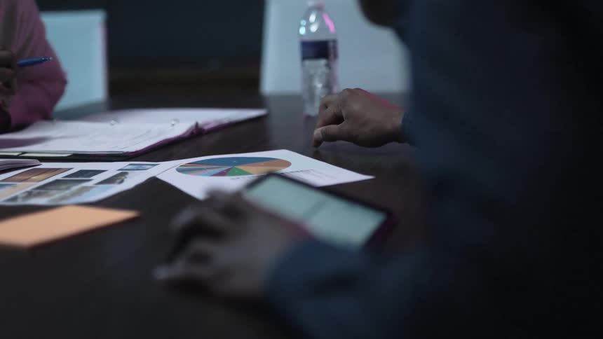 Employees look at documents in an office