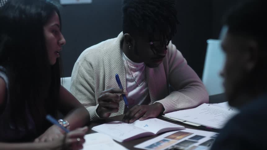 Group of teenagers working on their homework at a table