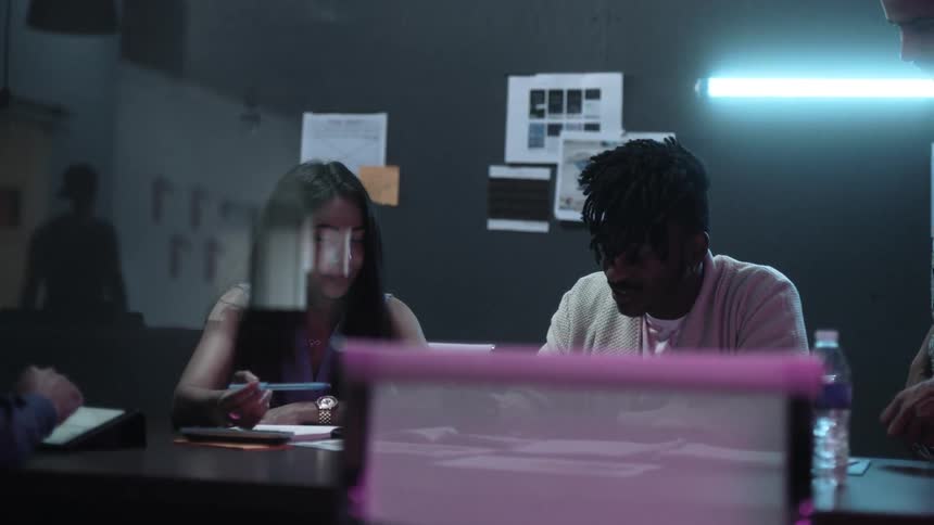 Workers in an office work together at a table