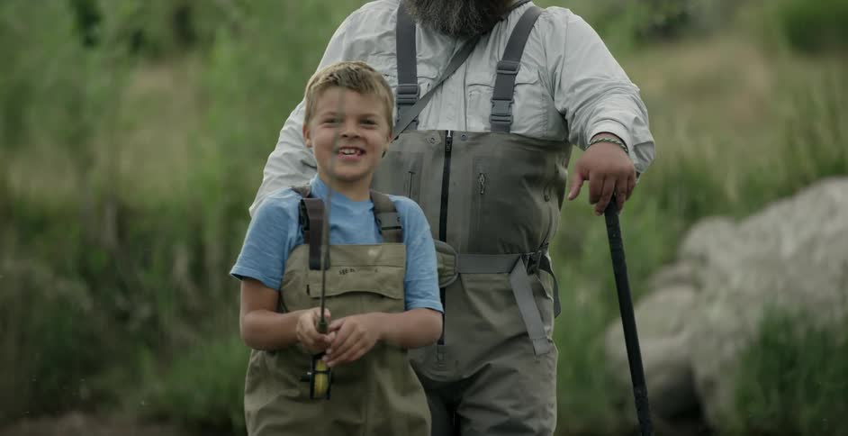 A young boy and his father are fishing