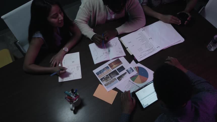 A group of young people are having a conference about charts and graphs