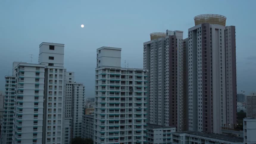 A timelapse video showing the darkness falling on the city as the moon rises above