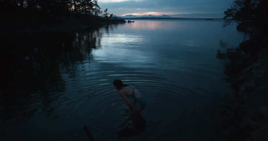 A woman washes off in a lake