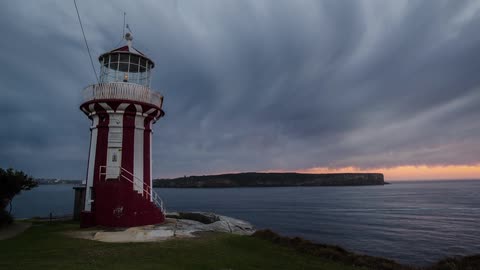 Time lapse video light blinking in a lighthouse which is situated by the sea