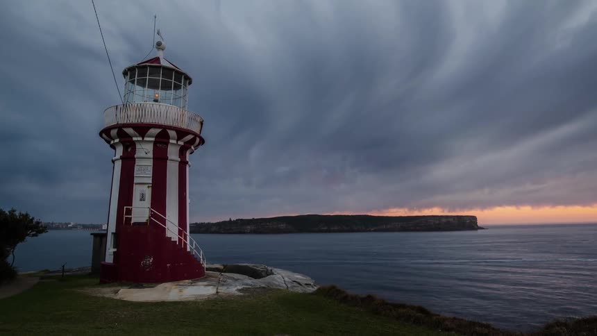 Time lapse video light blinking in a lighthouse which is situated by the sea