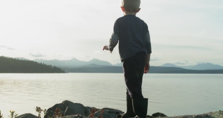 A boy plays near the beach
