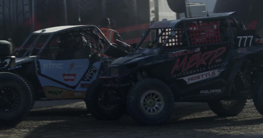 Race car coming to a stop next to another race car