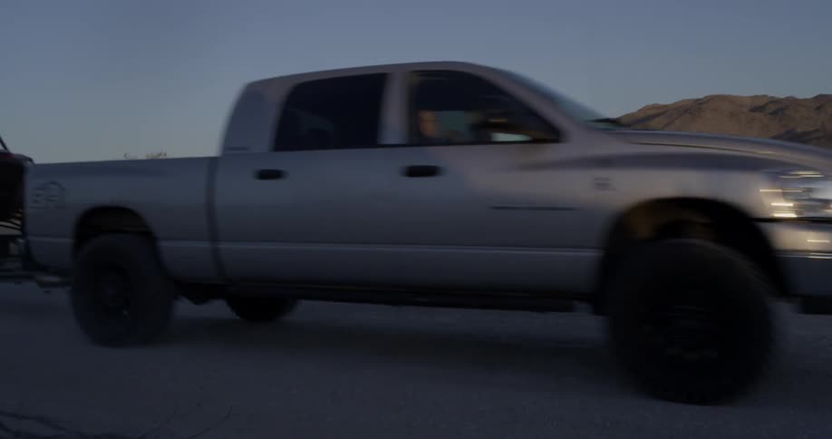 Truck drives across a desert road