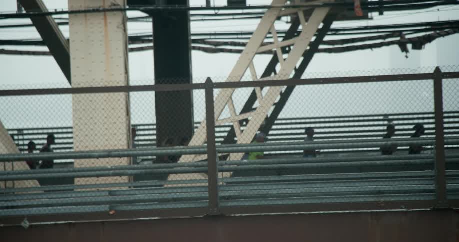 People jog across a bridge