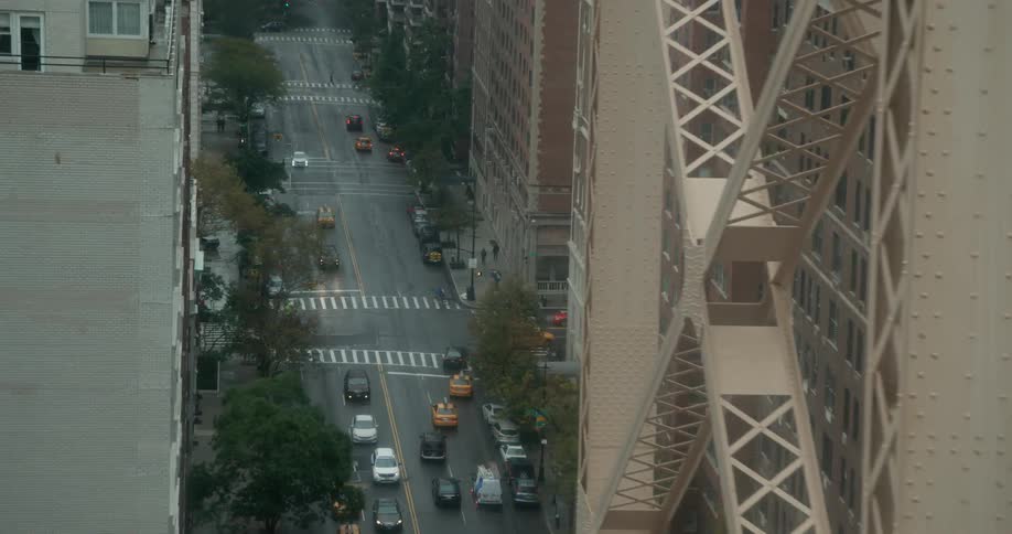 Vehicles travel along a busy city street
