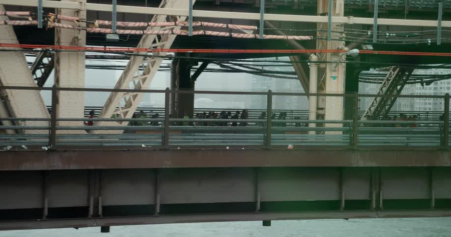 People walk across a city bridge