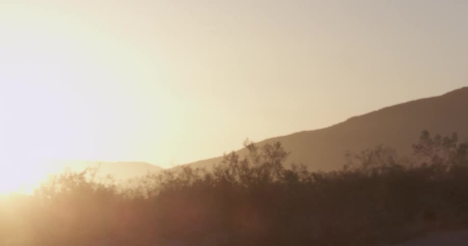 A truck drives through the desert
