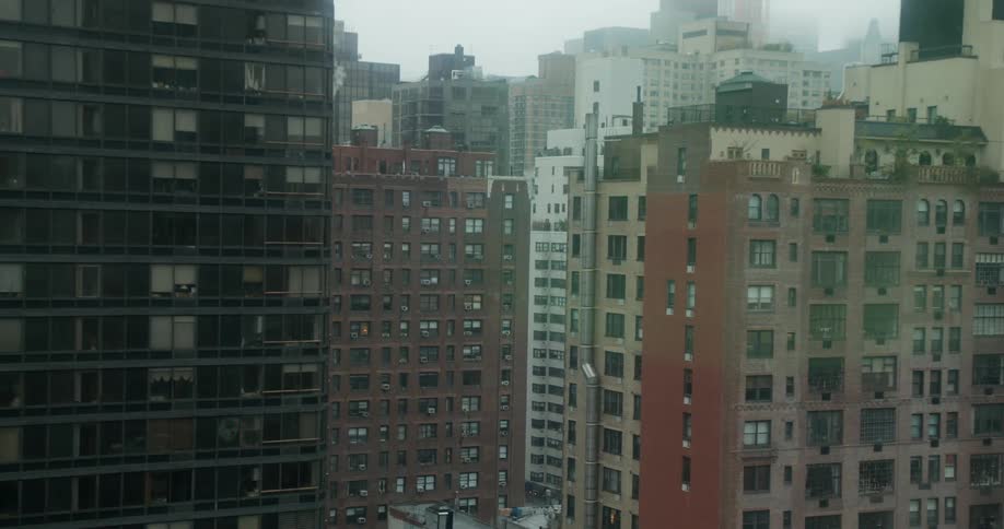A dense city on a foggy day
