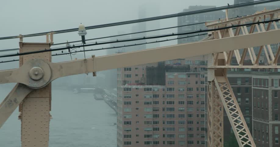 Behind the bridge the city is covered in fog