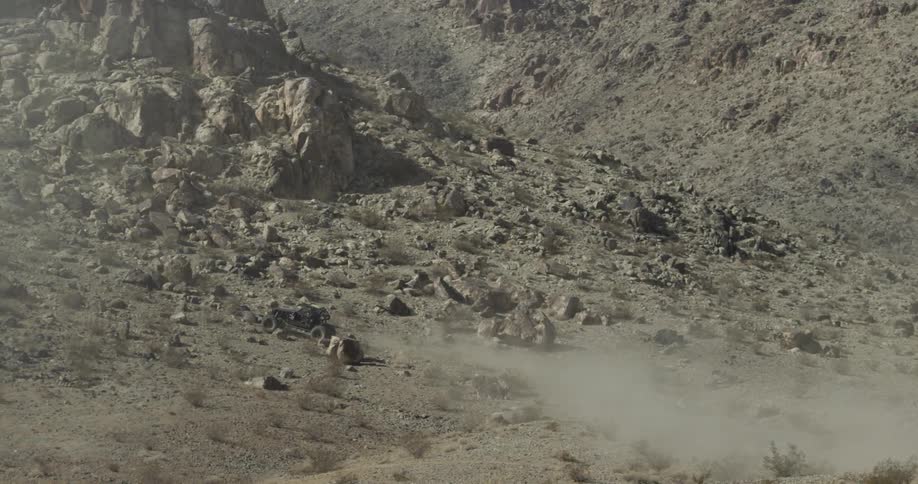 Race car driving on rocky terrain