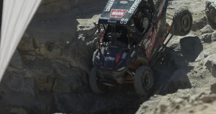 Car slowly driving down rocky landscape