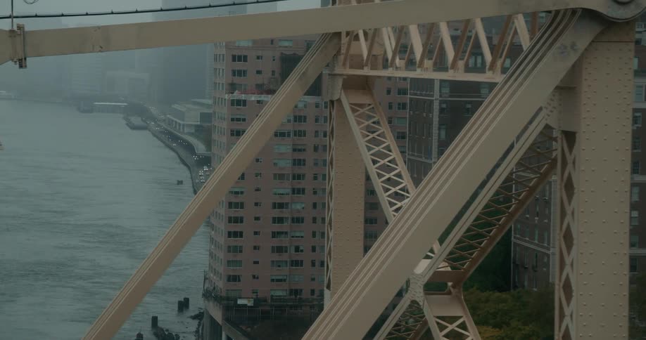 A city bridge is shown on a foggy day